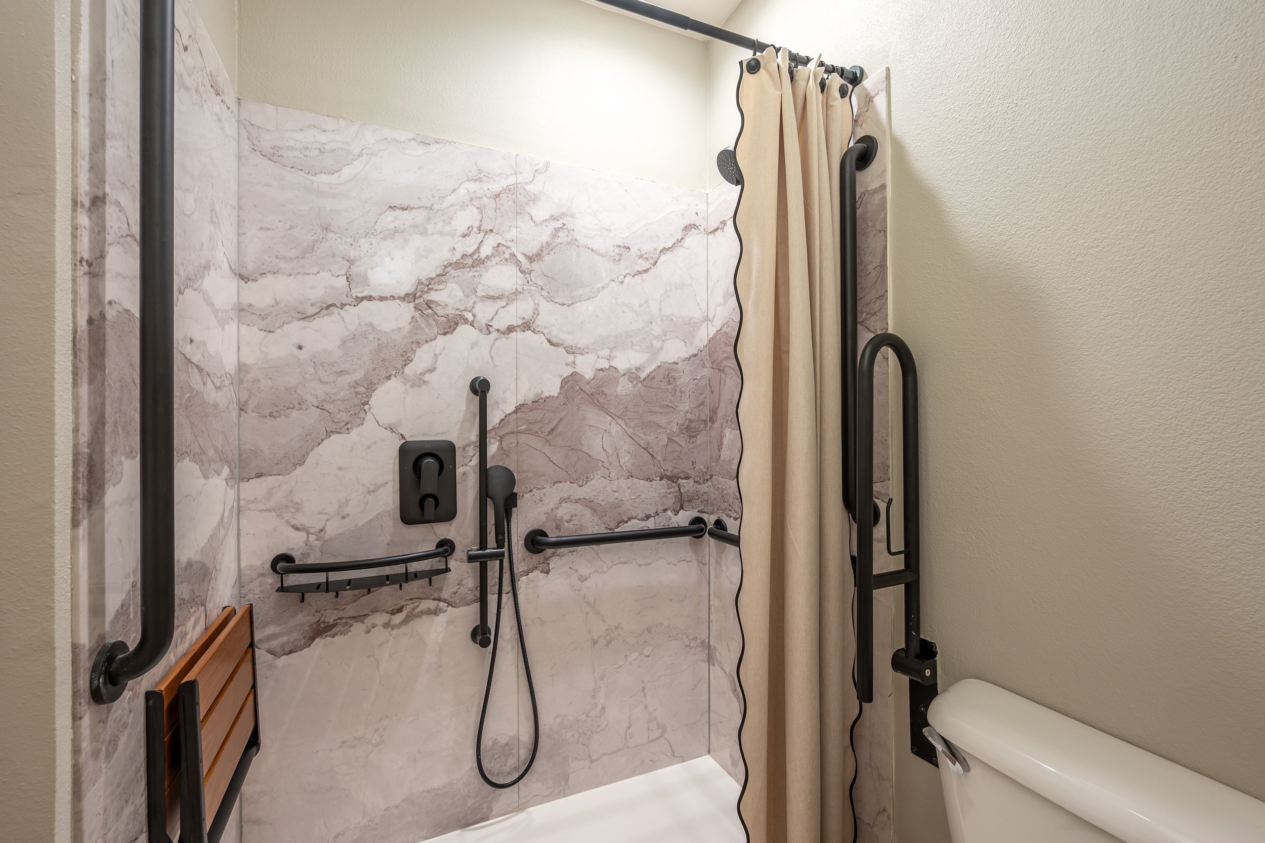 Accessible bathroom with grab bars and roll-in shower
